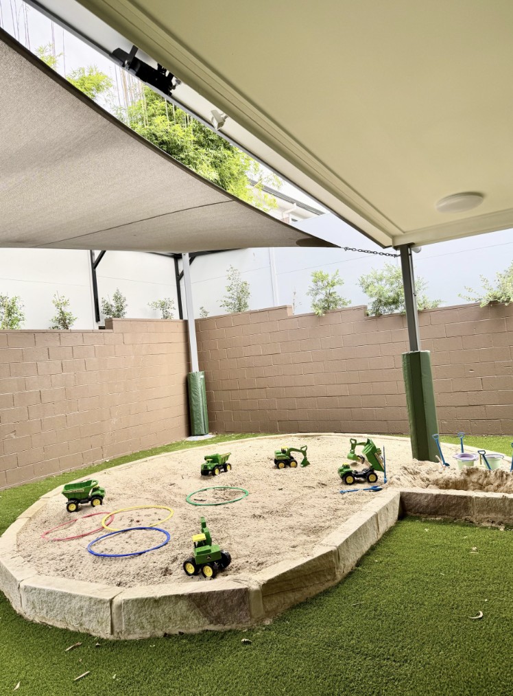 Shaded outdoor sand play area